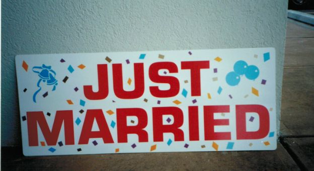 Just Married sign.  Confetti effect in the back makes for an exciting and colorful announcement.
